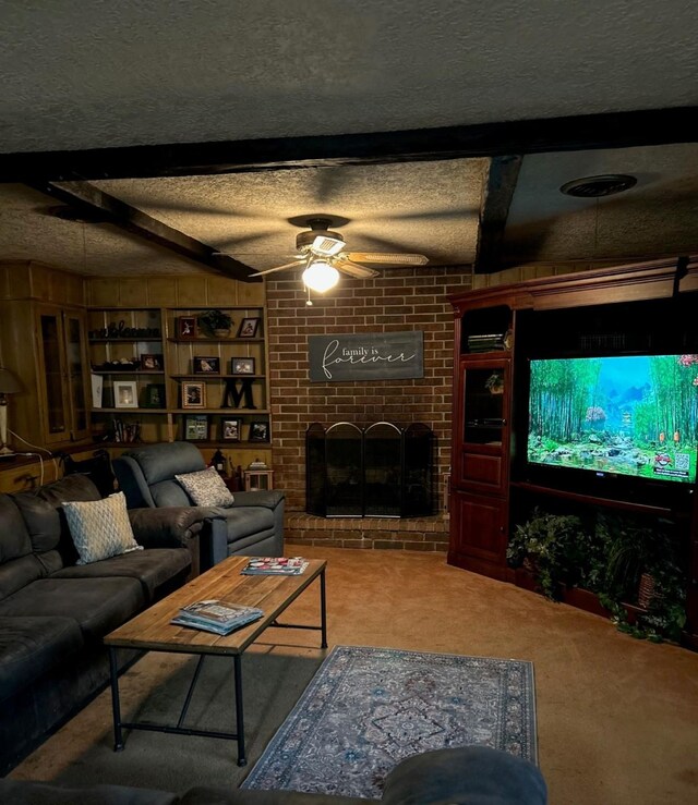 315 N Marsh Dr, Livingston, TX 77351 - living area with carpet flooring, a brick fireplace, ceiling fan, a textured ceiling, and beam ceiling