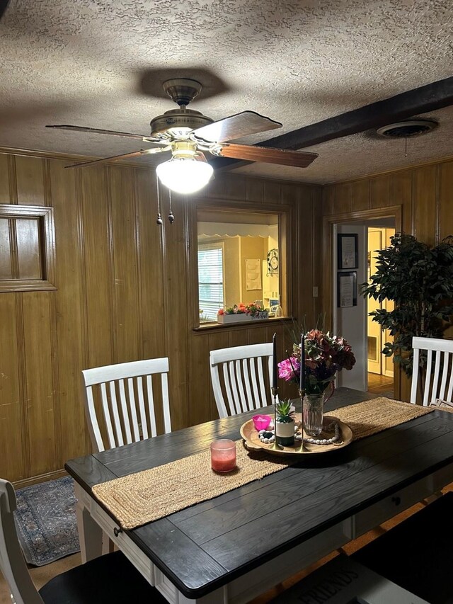 315 N Marsh Dr, Livingston, TX 77351 - dining area featuring a textured ceiling, ceiling fan, and wooden walls