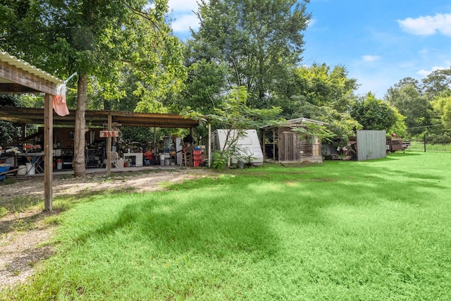 26145 Shadow Ln, New Caney, TX 77357 - view of grassy yard featuring a storage shed