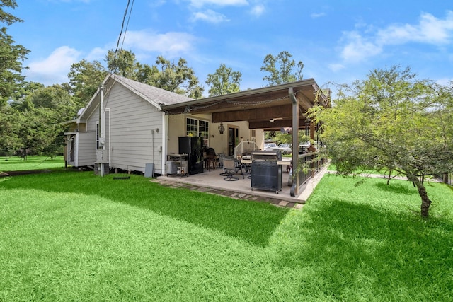 26145 Shadow Ln, New Caney, TX 77357 - rear view of house with a patio area and a lawn