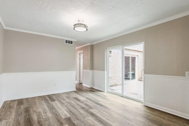 4710 N Cashel Cir, Houston, TX 77069 - spare room with a textured ceiling, wood finished floors, a wainscoted wall, and crown molding
