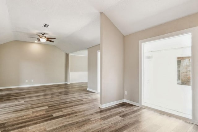 4710 N Cashel Cir, Houston, TX 77069 - empty room featuring a ceiling fan, vaulted ceiling, and wood finished floors