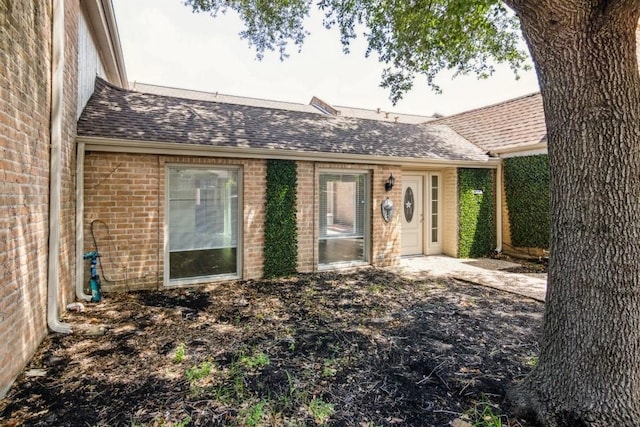 4710 N Cashel Cir, Houston, TX 77069 - view of exterior entry with brick siding and a shingled roof