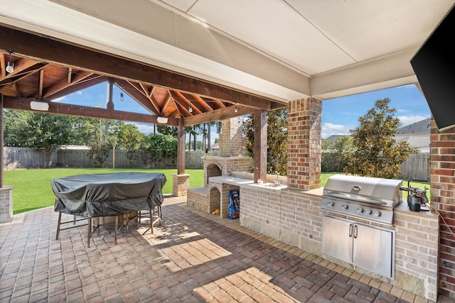 16003 Cypress Farms Dr, Cypress, TX 77429 - fenced backyard with an outdoor brick fireplace, exterior kitchen, a gazebo, and a patio area