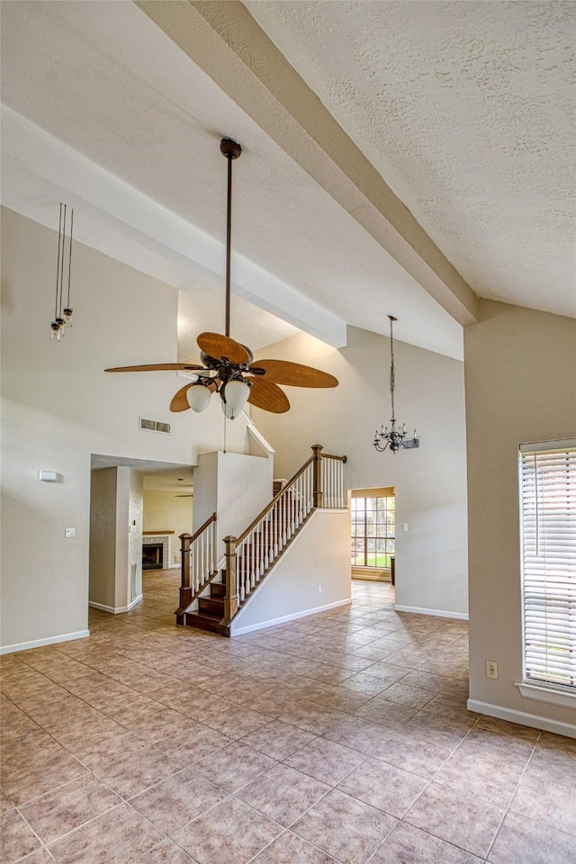 14715 Cobre Valley Dr, Houston, TX 77062 - unfurnished living room featuring a ceiling fan, stairway, high vaulted ceiling, a chandelier, and a fireplace