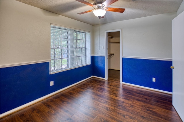 14715 Cobre Valley Dr, Houston, TX 77062 - unfurnished bedroom with a textured ceiling, a walk in closet, wood finished floors, a closet, and ceiling fan