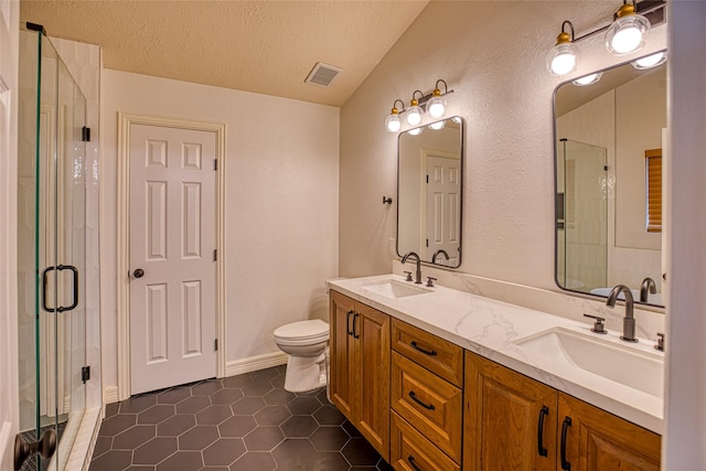 14715 Cobre Valley Dr, Houston, TX 77062 - full bath with double vanity, a textured ceiling, a stall shower, tile patterned floors, and a textured wall
