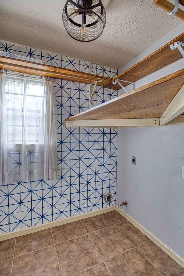 14715 Cobre Valley Dr, Houston, TX 77062 - washroom featuring hookup for an electric dryer, tile patterned floors, and a textured ceiling