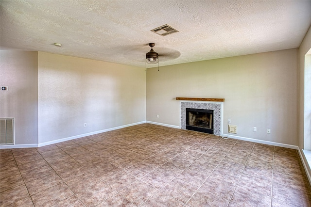14715 Cobre Valley Dr, Houston, TX 77062 - unfurnished living room featuring a ceiling fan, a fireplace, a textured ceiling, and tile patterned floors
