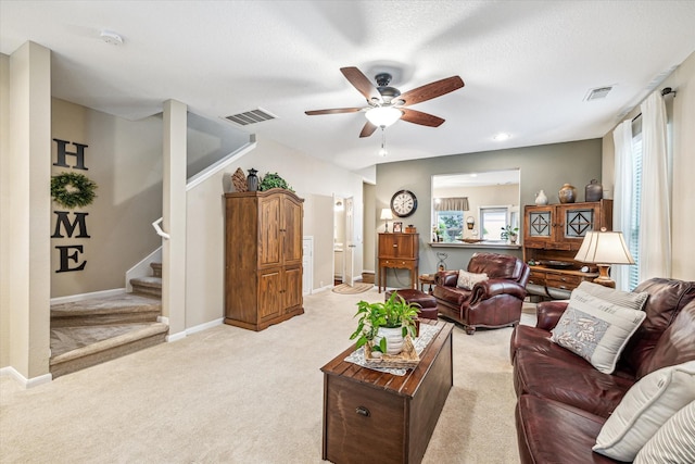 29708 Parliament Hills Dr, Spring, TX 77386 - living room featuring ceiling fan, light colored carpet, and stairs