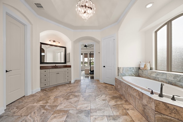 28106 Island Manor Ln, Fulshear, TX 77441 - bathroom featuring vanity, a garden tub, ornamental molding, a ceiling fan, and stone tile floors