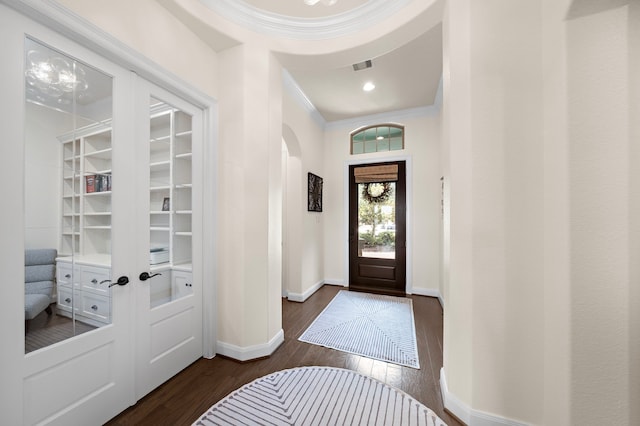 28106 Island Manor Ln, Fulshear, TX 77441 - entrance foyer featuring dark wood-type flooring, ornamental molding, and arched walkways