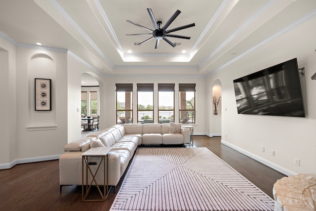28106 Island Manor Ln, Fulshear, TX 77441 - living room with arched walkways, plenty of natural light, a ceiling fan, a tray ceiling, and ornamental molding