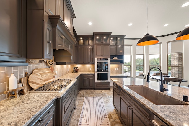 28106 Island Manor Ln, Fulshear, TX 77441 - kitchen featuring appliances with stainless steel finishes, tasteful backsplash, recessed lighting, crown molding, and pendant lighting