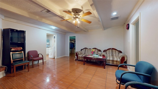 9030 Troulon Dr, Houston, TX 77036 - sitting room featuring ceiling fan, beam ceiling, a textured ceiling, light tile patterned flooring, and recessed lighting