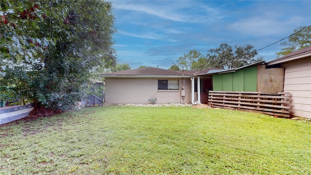 9030 Troulon Dr, Houston, TX 77036 - rear view of house featuring a lawn and brick siding