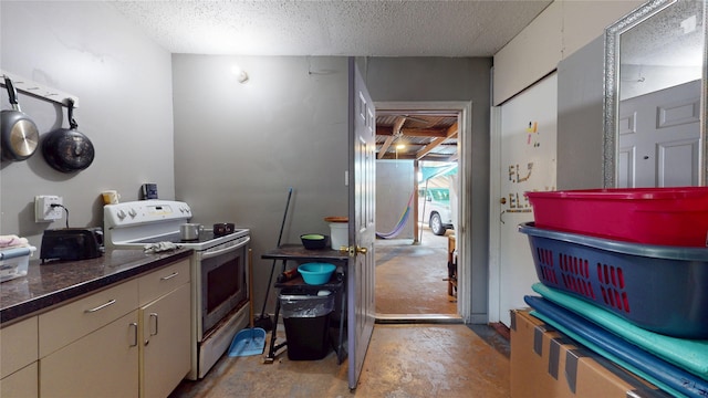 9030 Troulon Dr, Houston, TX 77036 - kitchen featuring electric stove, concrete floors, and a textured ceiling