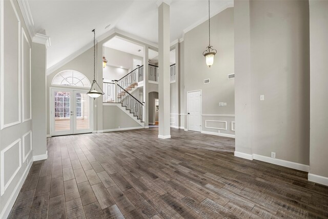 1123 Misty Lake Dr, Sugar Land, TX 77498 - unfurnished living room featuring high vaulted ceiling, dark wood-type flooring, stairway, crown molding, and french doors