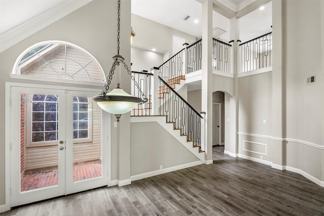 1123 Misty Lake Dr, Sugar Land, TX 77498 - foyer entrance with arched walkways, a high ceiling, wood finished floors, french doors, and stairs