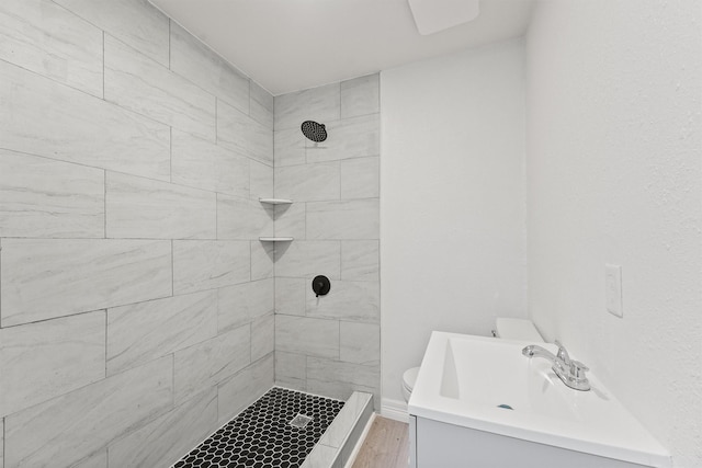1615 Hiller St, Houston, TX 77015 - bathroom with vanity, a tile shower, and wood finished floors