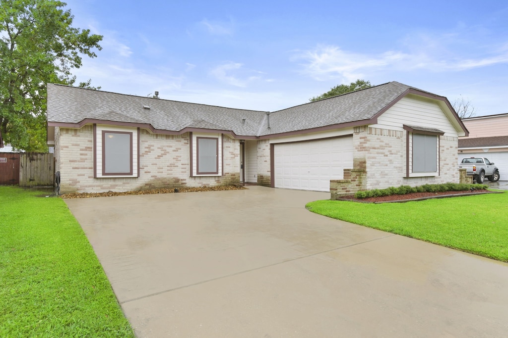 14707 Payette Dr, Houston, TX 77040 - view of front of property with brick siding, driveway, and roof with shingles