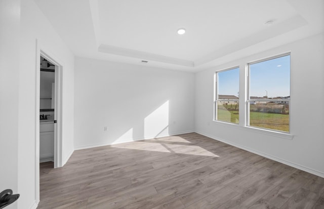 31727 Valor Dr, Fulshear, TX 77441 - unfurnished room with a tray ceiling, wood finished floors, and recessed lighting