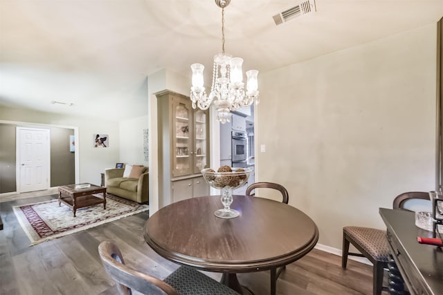 1721 Bowline Rd, Houston, TX 77062 - dining room with dark wood finished floors and a chandelier