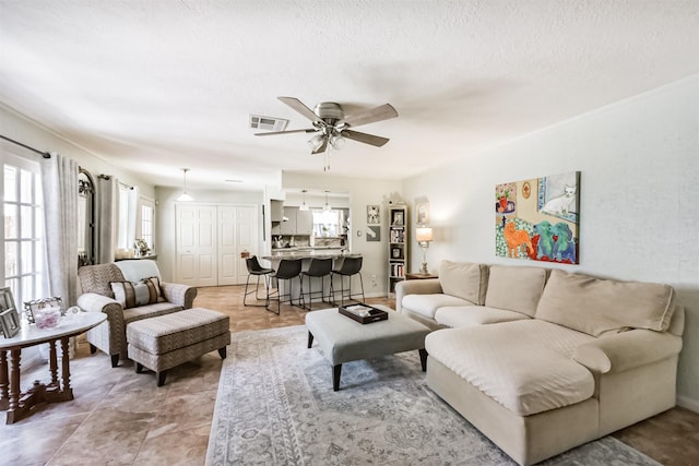 1721 Bowline Rd, Houston, TX 77062 - living area with plenty of natural light, a ceiling fan, and a textured ceiling