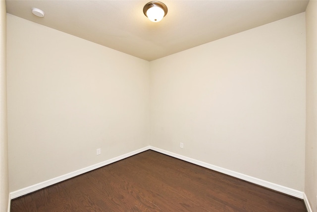9428 Caddo Ridge Ln, Cypress, TX 77433 - unfurnished room with dark wood-style flooring and a smoke detector
