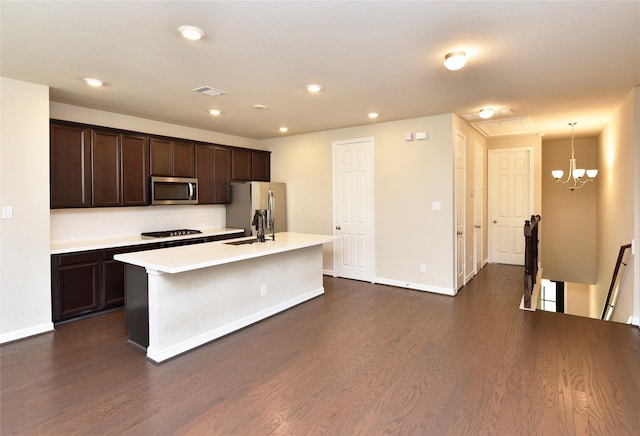 9428 Caddo Ridge Ln, Cypress, TX 77433 - kitchen with stainless steel appliances, dark brown cabinets, light countertops, a center island with sink, and recessed lighting