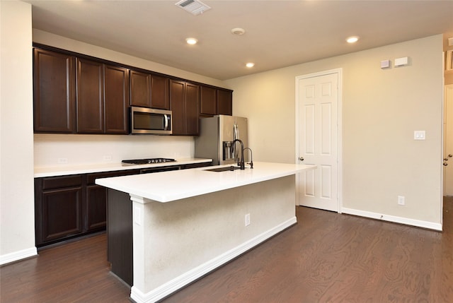 9428 Caddo Ridge Ln, Cypress, TX 77433 - kitchen featuring appliances with stainless steel finishes, dark wood-style flooring, dark brown cabinets, and recessed lighting