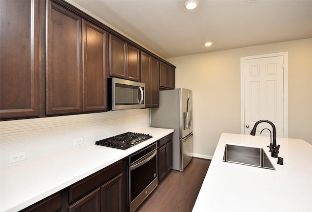 9428 Caddo Ridge Ln, Cypress, TX 77433 - kitchen featuring stainless steel appliances, dark wood-type flooring, dark brown cabinetry, decorative backsplash, and light countertops