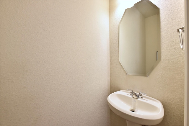 9428 Caddo Ridge Ln, Cypress, TX 77433 - bathroom with a sink and a textured wall