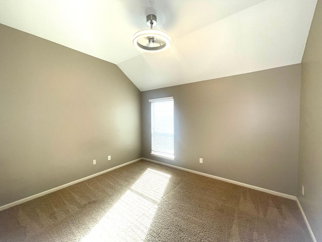 28215 Goose Creek Ct, Fulshear, TX 77441 - carpeted empty room featuring baseboards and vaulted ceiling