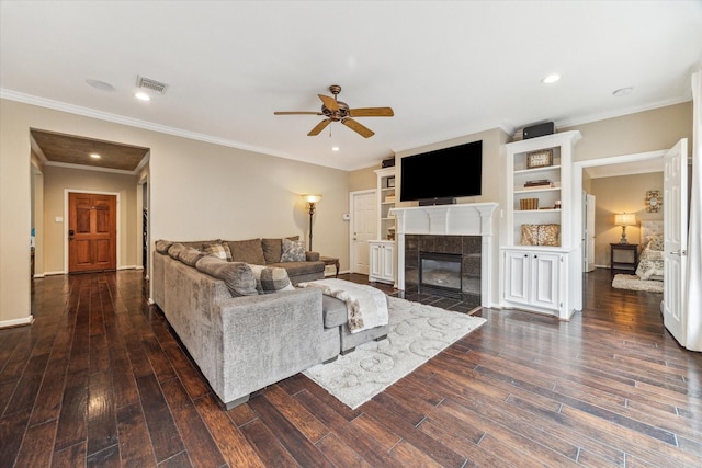 1440 Waseca St, Houston, TX 77055 - living area featuring a ceiling fan, a fireplace, dark wood-style floors, crown molding, and recessed lighting
