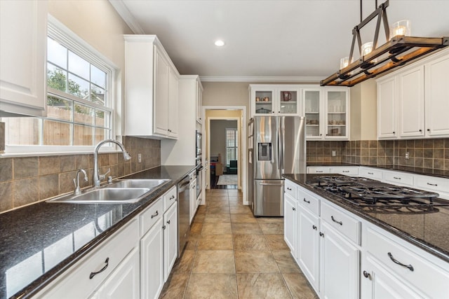 1440 Waseca St, Houston, TX 77055 - kitchen featuring appliances with stainless steel finishes, white cabinets, glass insert cabinets, ornamental molding, and tasteful backsplash