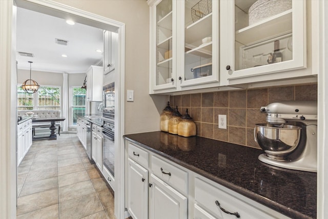 1440 Waseca St, Houston, TX 77055 - kitchen featuring backsplash, white cabinetry, oven, recessed lighting, and crown molding