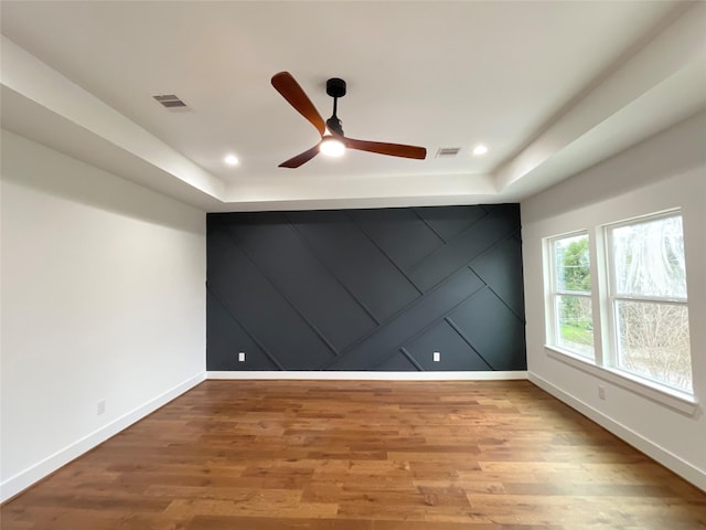 3038 Webster St, Houston, TX 77004 - empty room featuring a ceiling fan, wood finished floors, an accent wall, recessed lighting, and a decorative wall
