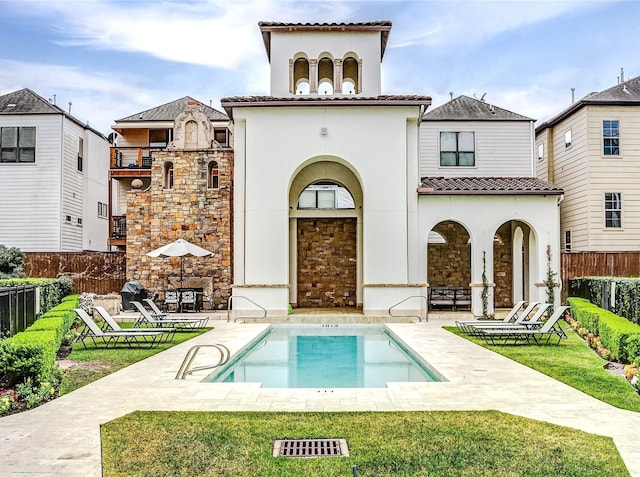 5327 Paseo Caceres Dr, Houston, TX 77007 - rear view of house with stone siding, stucco siding, a patio area, and a tile roof