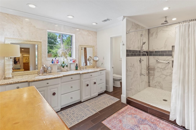 8220 Wateka Cir, Houston, TX 77074 - bathroom featuring ornamental molding, a shower stall, double vanity, wood tiled floors, and recessed lighting