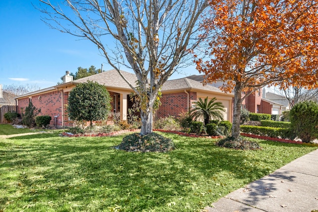9710 Golden Park Ln, Houston, TX 77088 - view of front of house featuring brick siding, a front lawn, a chimney, and an attached garage