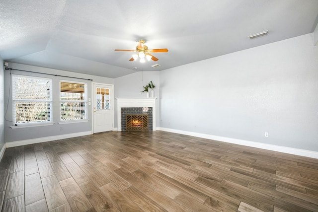 9710 Golden Park Ln, Houston, TX 77088 - unfurnished living room featuring ceiling fan, wood finished floors, a fireplace, and lofted ceiling