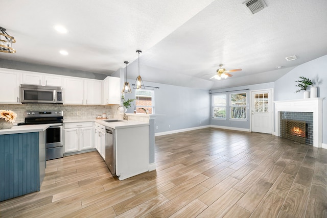 9710 Golden Park Ln, Houston, TX 77088 - kitchen featuring stainless steel appliances, ceiling fan, open floor plan, tasteful backsplash, and recessed lighting