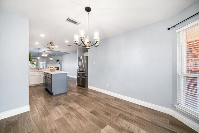 9710 Golden Park Ln, Houston, TX 77088 - kitchen featuring stainless steel fridge, a chandelier, dark wood-style floors, light countertops, and recessed lighting