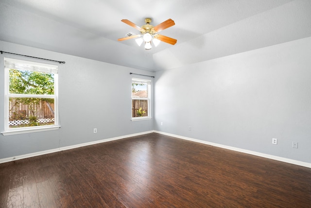 9710 Golden Park Ln, Houston, TX 77088 - unfurnished room with plenty of natural light, dark wood finished floors, a ceiling fan, and lofted ceiling