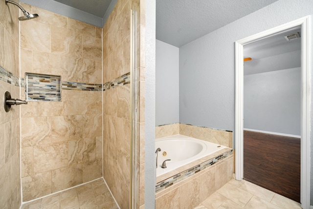 9710 Golden Park Ln, Houston, TX 77088 - bathroom featuring a whirlpool tub, a stall shower, and tile patterned floors
