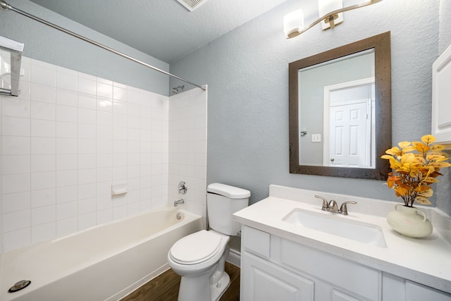 9710 Golden Park Ln, Houston, TX 77088 - full bath with wood finished floors, vanity, washtub / shower combination, and a textured wall