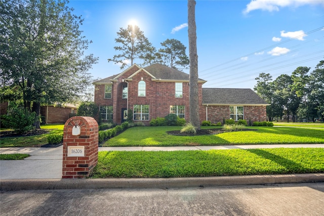 16206 Lakewood Field Dr, Tomball, TX 77377 - view of front of house with a front lawn, brick siding, and a shingled roof