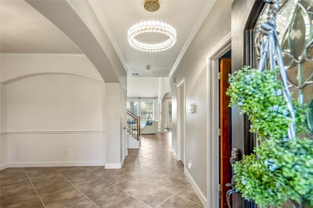 16206 Lakewood Field Dr, Tomball, TX 77377 - hallway with arched walkways, a chandelier, crown molding, tile patterned flooring, and stairway