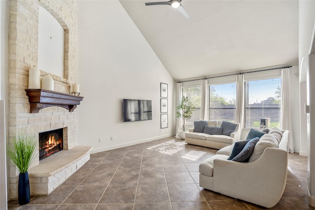 16206 Lakewood Field Dr, Tomball, TX 77377 - living area with high vaulted ceiling, a stone fireplace, ceiling fan, and tile patterned flooring